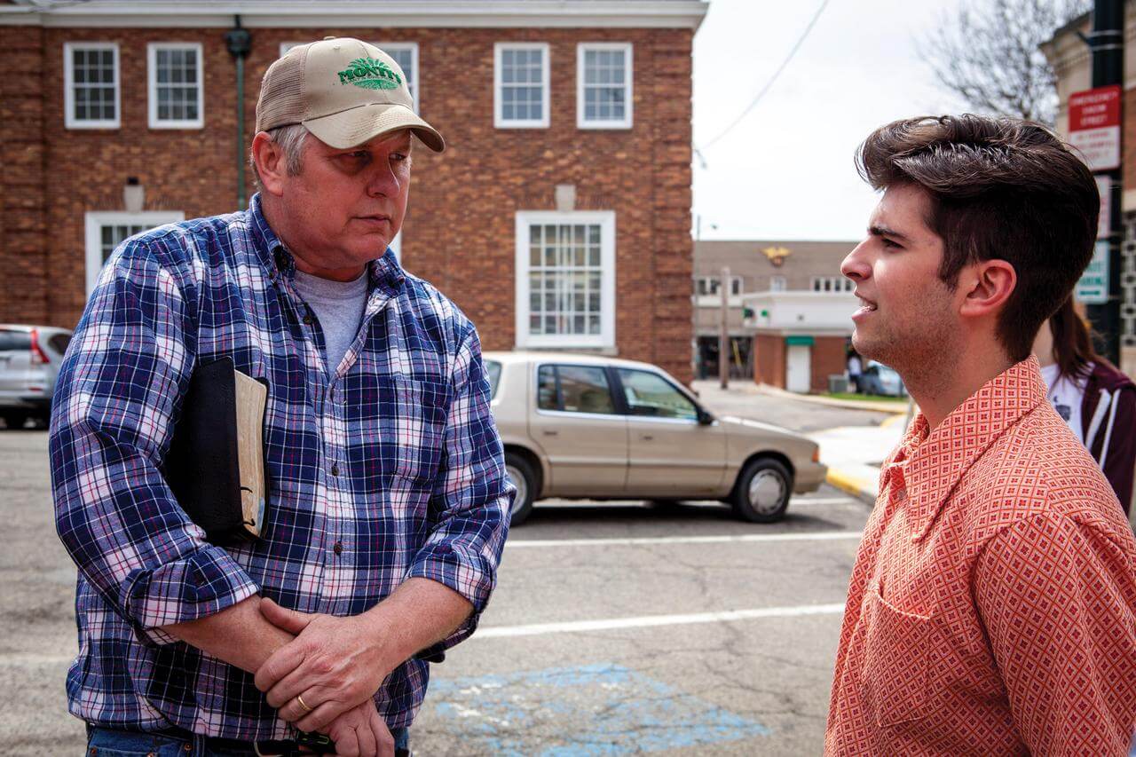 Kenyon student George Costanzo and Pastor Bill Dunfee of New Beginnings Church talk in the Mount Vernon town square.