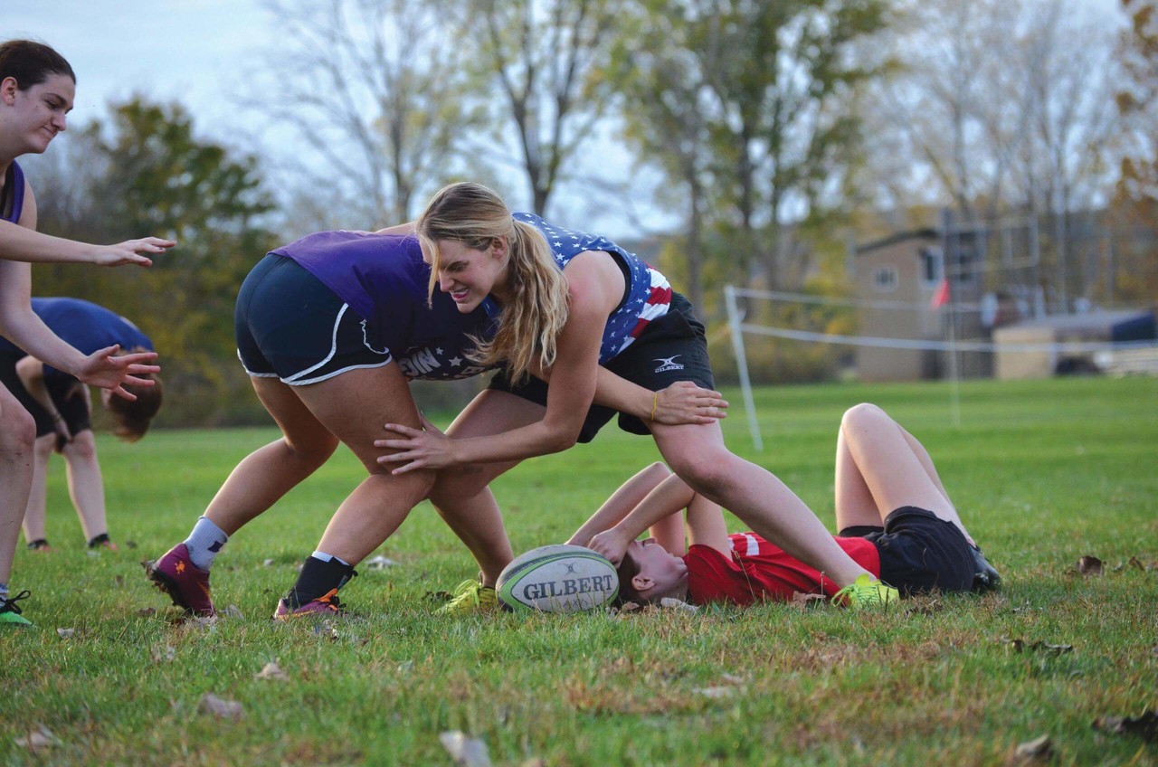 Kenyon student rugby players grapple over the ball