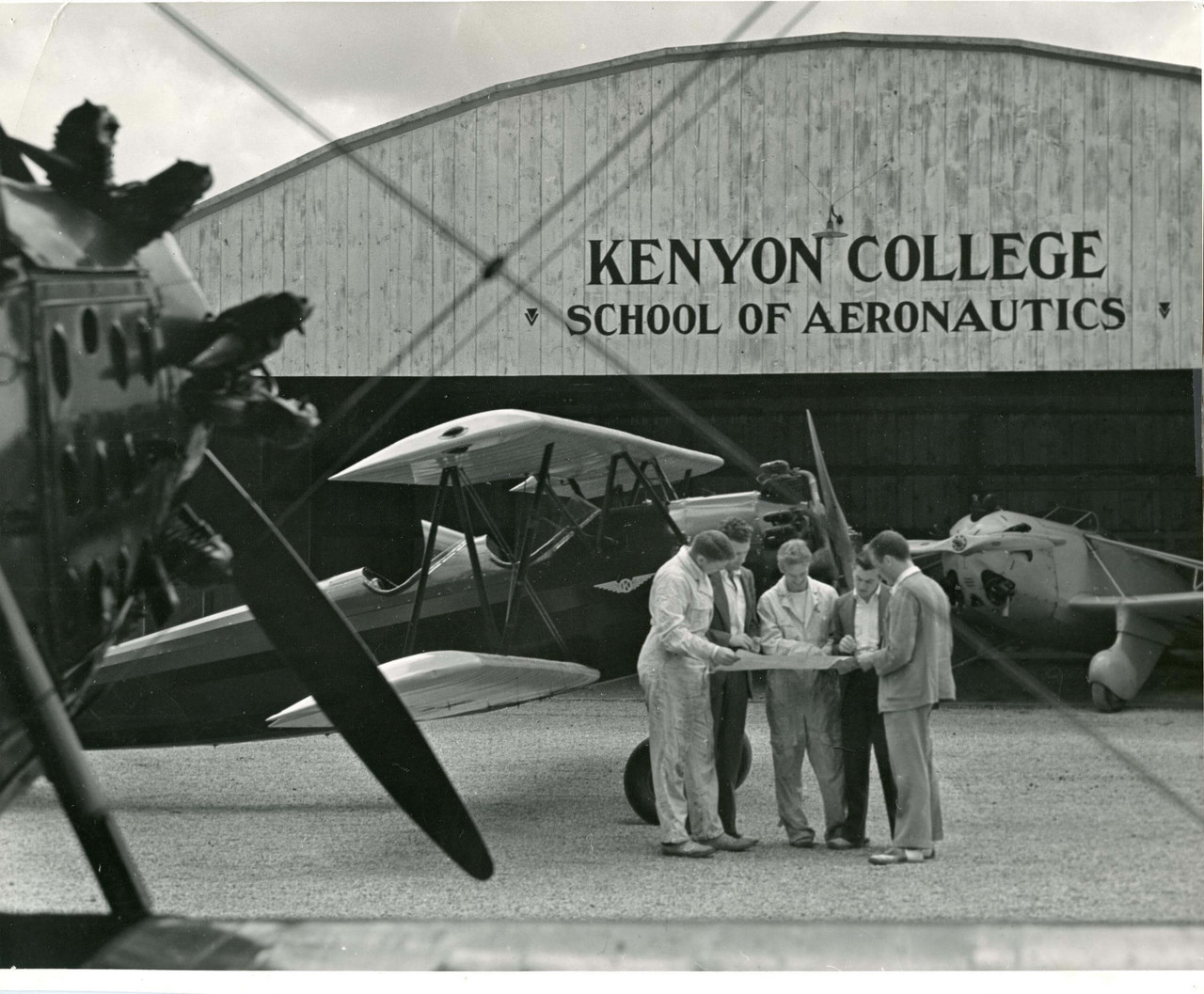 Students enrolled in Kenyon College’s School of Aeronautics gather outside the hangar to look over flight plans.